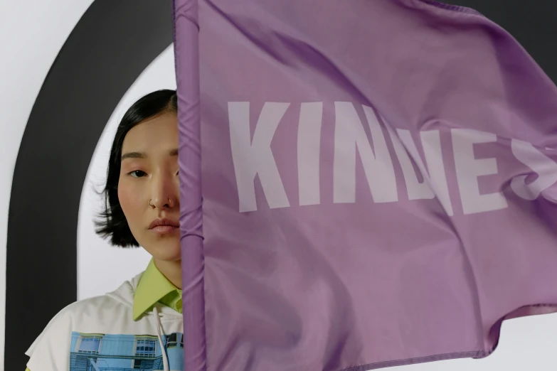 a woman in overalls holding a purple flag, an album cover, inspired by Kim Tschang Yeul, kinetic art, close-up portrait film still, ignant, kidmo!!!, kindness