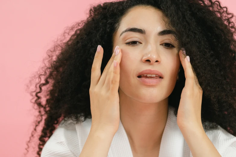 a woman with curly hair holding her hands to her face, trending on pexels, renaissance, glowing pink face, face muscles, manuka, woman with black hair