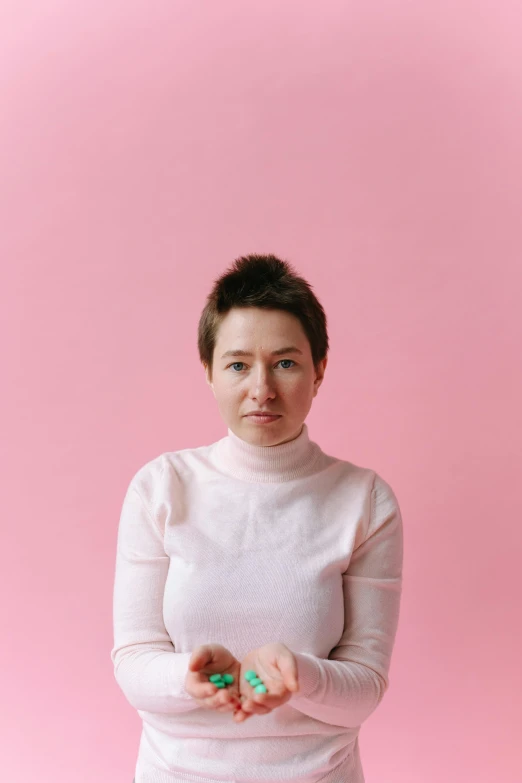 a woman holding a doughnut in her hands, an album cover, by Winona Nelson, minimalism, shaven, ((pink)), zellk, wearing turtleneck