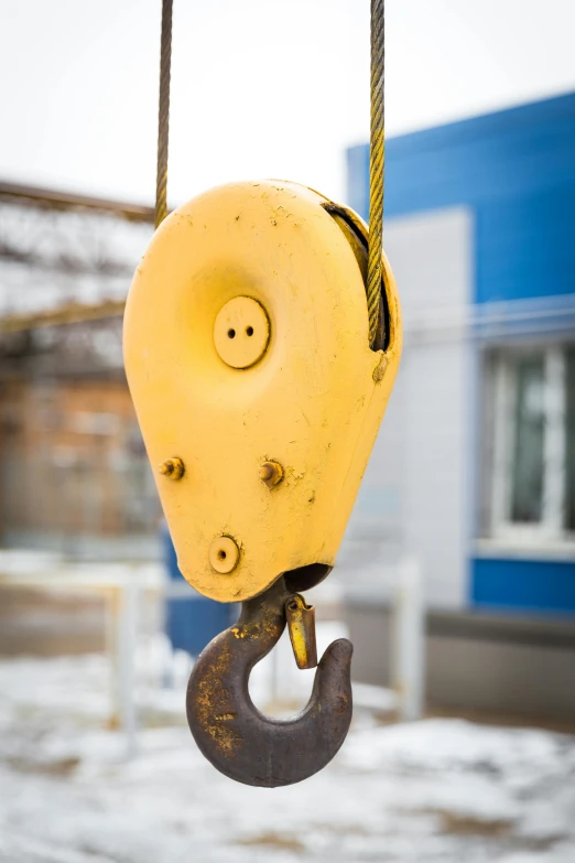 a crane hook hanging from the side of a building, a portrait, unsplash, smooth oval head, inspect in inventory image, square jaw-line, worn