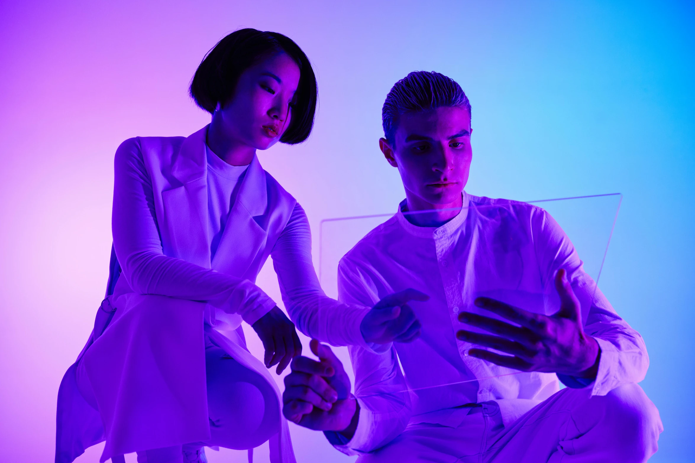 a man and a woman sitting next to each other, antipodeans, soft neon purple lighting, light clothing, jordan grimmer and natasha tan, julian ope