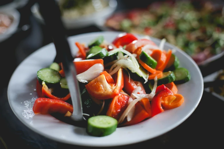 a close up of a plate of food on a table, by Julia Pishtar, pexels contest winner, veggies, salad, paprika, multiple stories