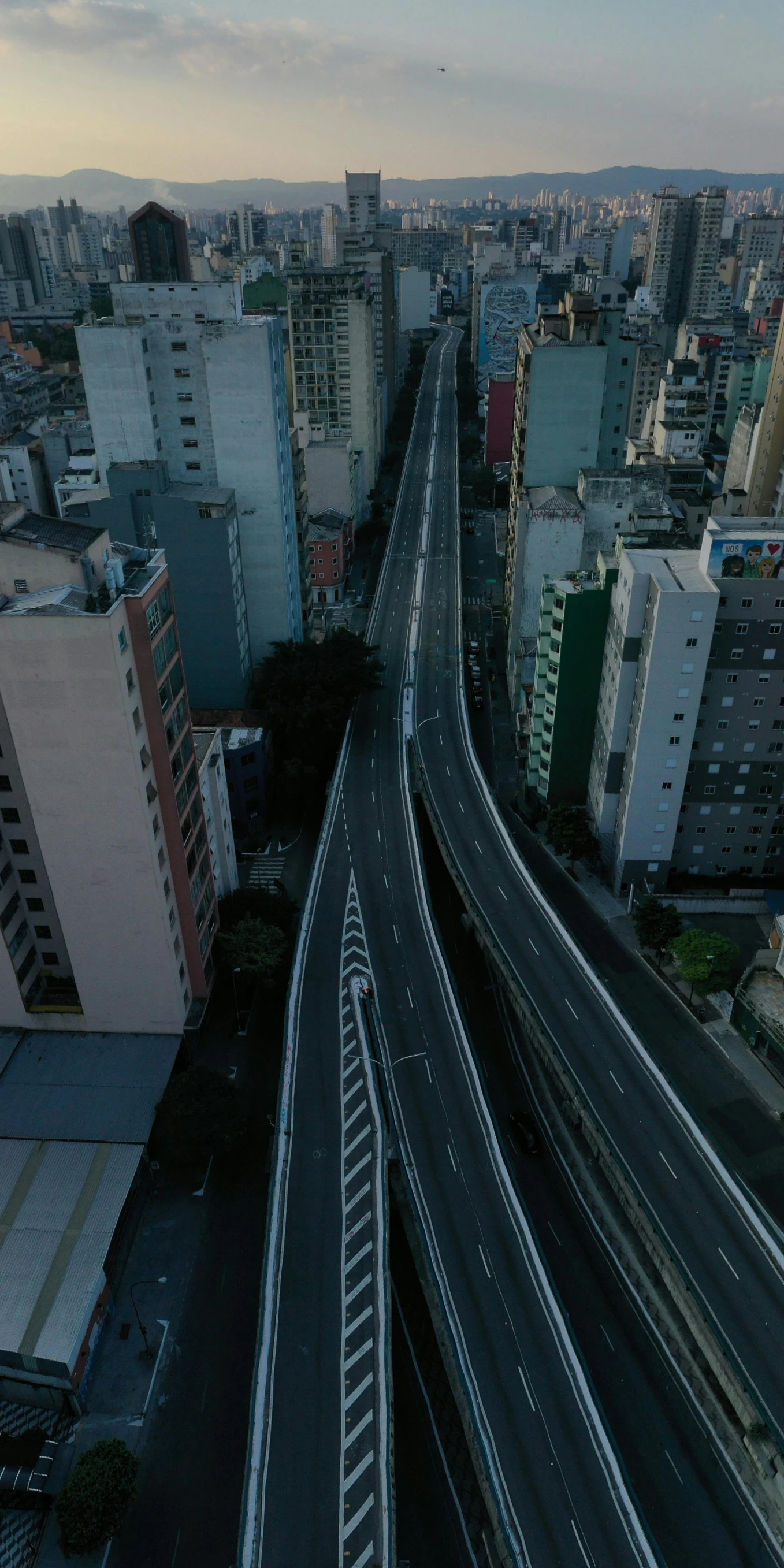 a city filled with lots of tall buildings, by Manuel Franquelo, unsplash contest winner, photorealism, highway, japanese town, drone photo, 8 k movie still