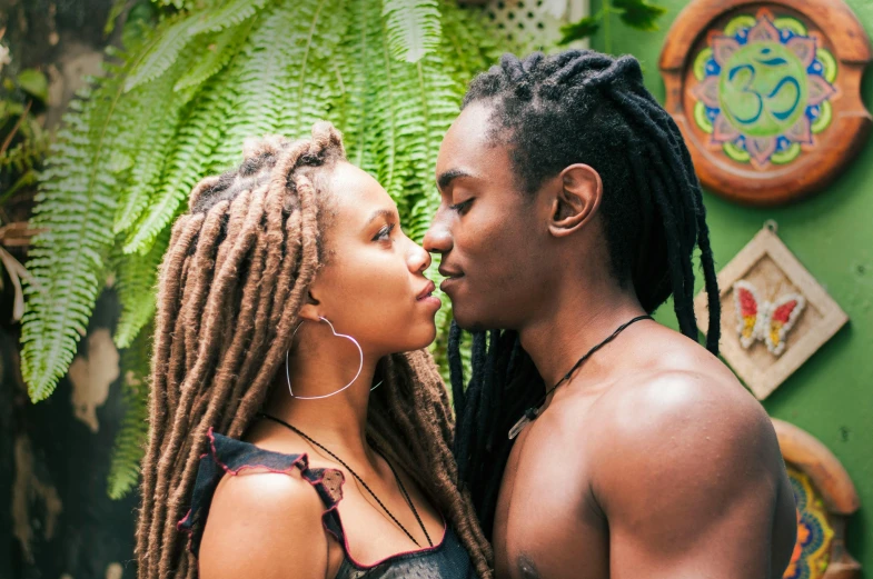 a man and a woman standing next to each other, trending on pexels, renaissance, dreadlock hair, kissing, lush paradise, jamaican colors