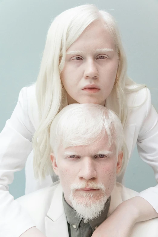a man and a woman sitting next to each other, an album cover, inspired by Louisa Matthíasdóttir, trending on reddit, intense albino, patricia piccinini, platinum blond, whiteout eyes