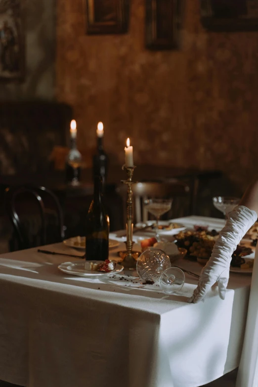 a table that has a bunch of food on it, inspired by Elsa Bleda, pexels contest winner, australian tonalism, elegant victorian vampire, white elbow gloves, candlelit catacombs, photo of a model