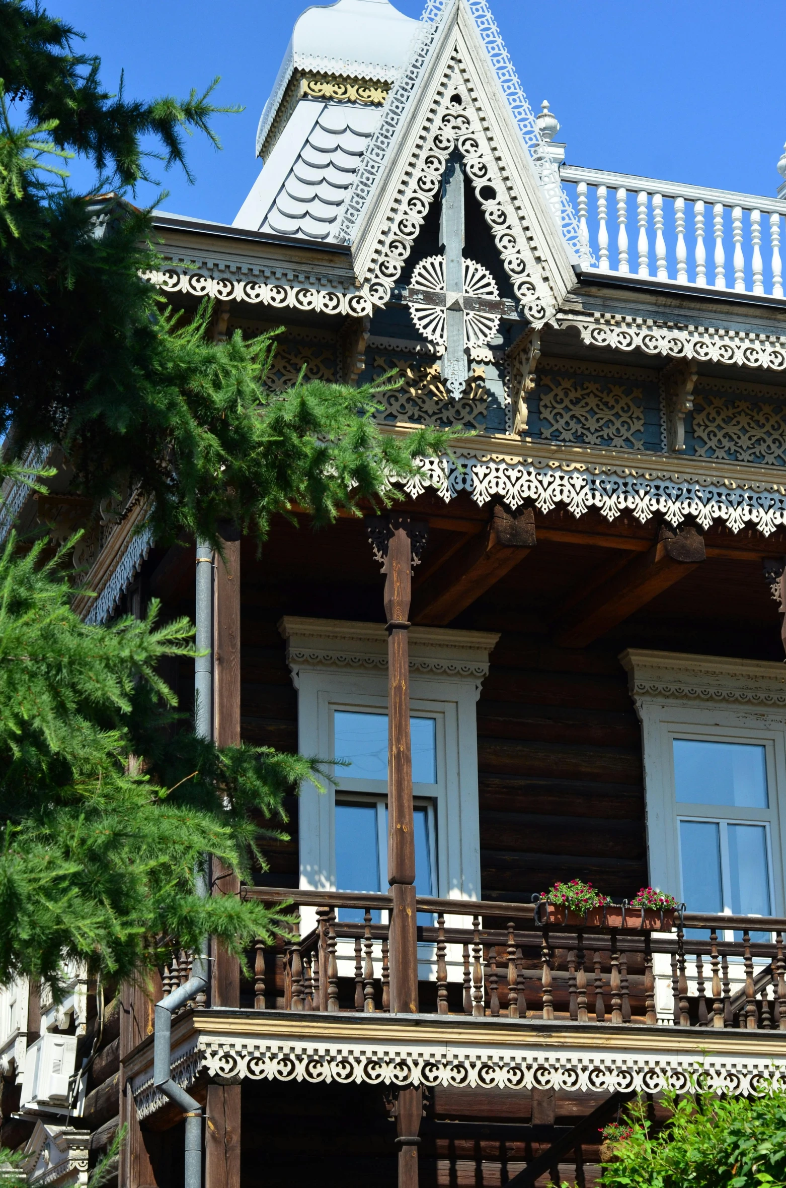 a building with a clock on the front of it, inspired by Nikolay Makovsky, chalet, hoog detail, balcony, taken in the late 2010s