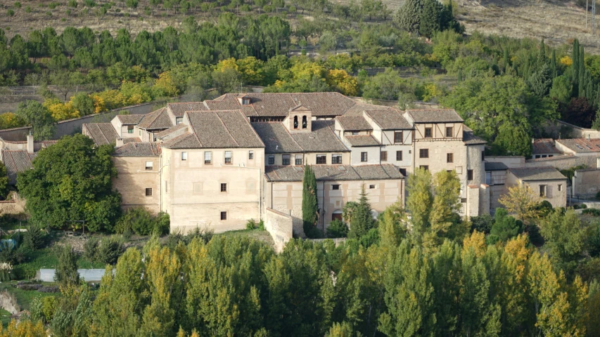 a large building sitting on top of a lush green hillside, inspired by Luis Paret y Alcazar, atlach - nacha, exterior shot, overview, bocages