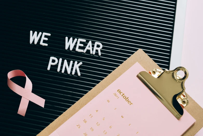 a clipboard that has a pink ribbon on it, trending on unsplash, happening, diverse outfits, pink and gold, fashion week, trendy typography