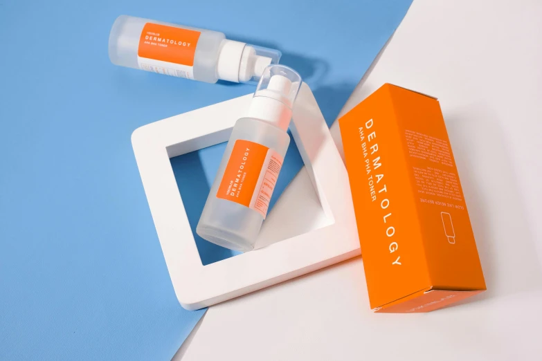 a white box sitting on top of a blue and white table, light orange mist, photoshoot for skincare brand, neon orange, transparent