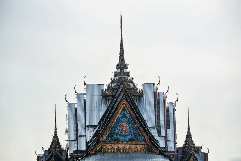 a large building with a clock on top of it, an album cover, unsplash, cloisonnism, thai architecture, asymmetrical spires, high details photo, courtesy of centre pompidou