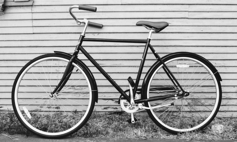 a black and white photo of a bicycle leaning against a wall, full width, prototype, recreation, very detailed »