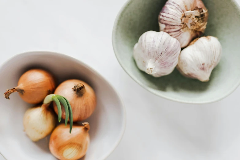 a bowl of onions and a bowl of garlic, by Niko Henrichon, trending on unsplash, fan favorite, vegetables, on a pale background, three michelin star