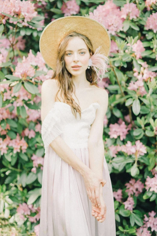 a woman wearing a hat standing in front of flowers, inspired by Oleg Oprisco, unsplash, renaissance, wedding, white and pink, 15081959 21121991 01012000 4k, kaya scodelario