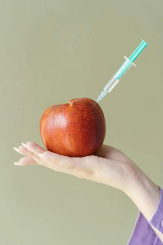 a person holding an apple with a syssor in their hand, an album cover, by Maeda Masao, shutterstock, holding syringe, 2 5 6 x 2 5 6 pixels, coronavirus, food