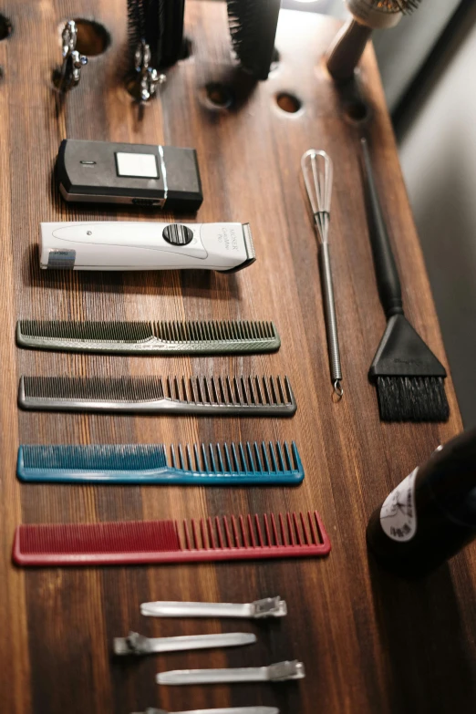 a table topped with lots of different types of hair brushes, items and gadget, modern haircut, exploration, trident