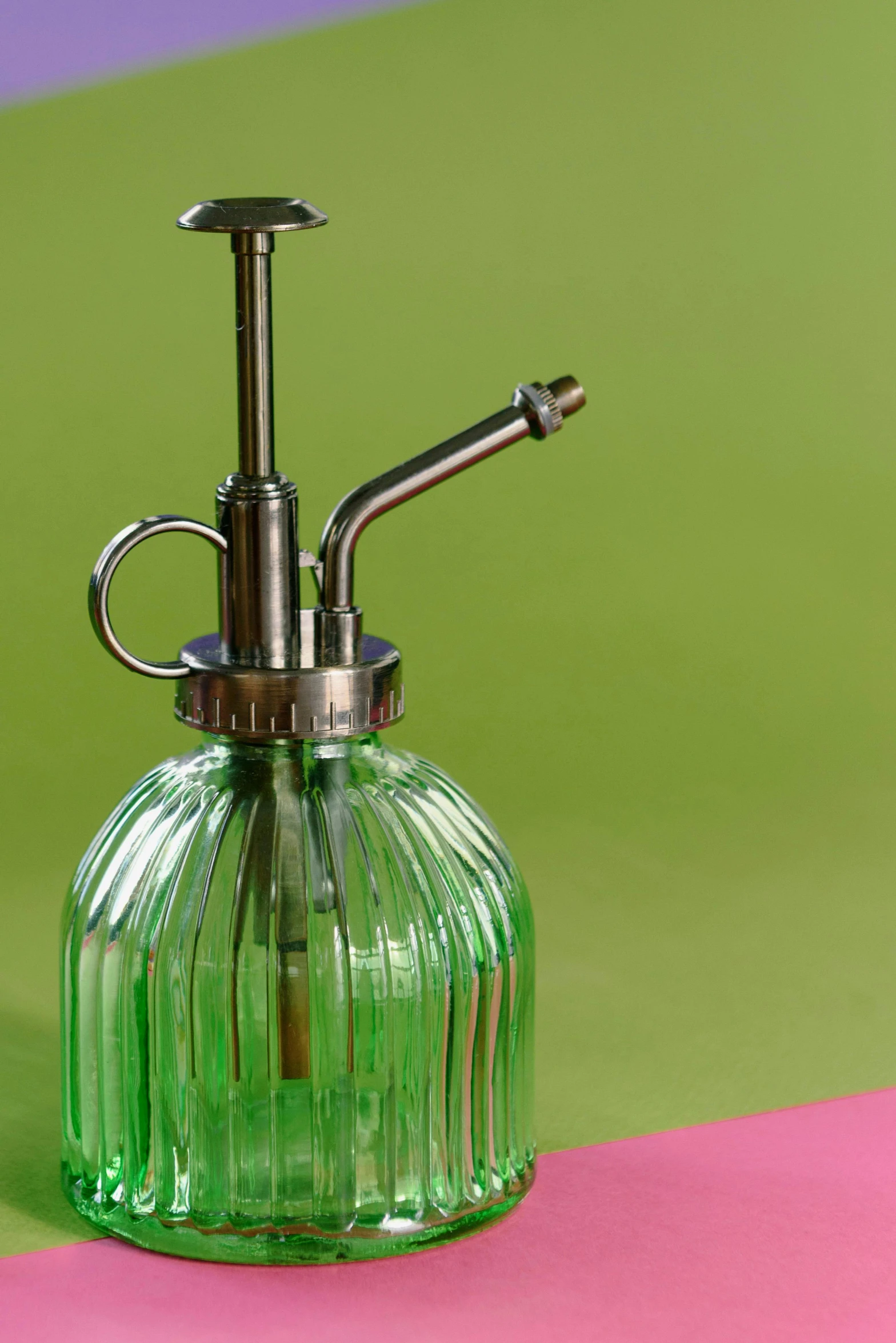 a green glass soap dispenser on a pink and green background, by Julian Allen, watering can, medium detail, striped, displayed