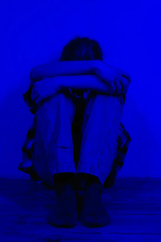 a person sitting on the floor with their head in their hands, a picture, antipodeans, royal blue colors, depression, hug, profile image