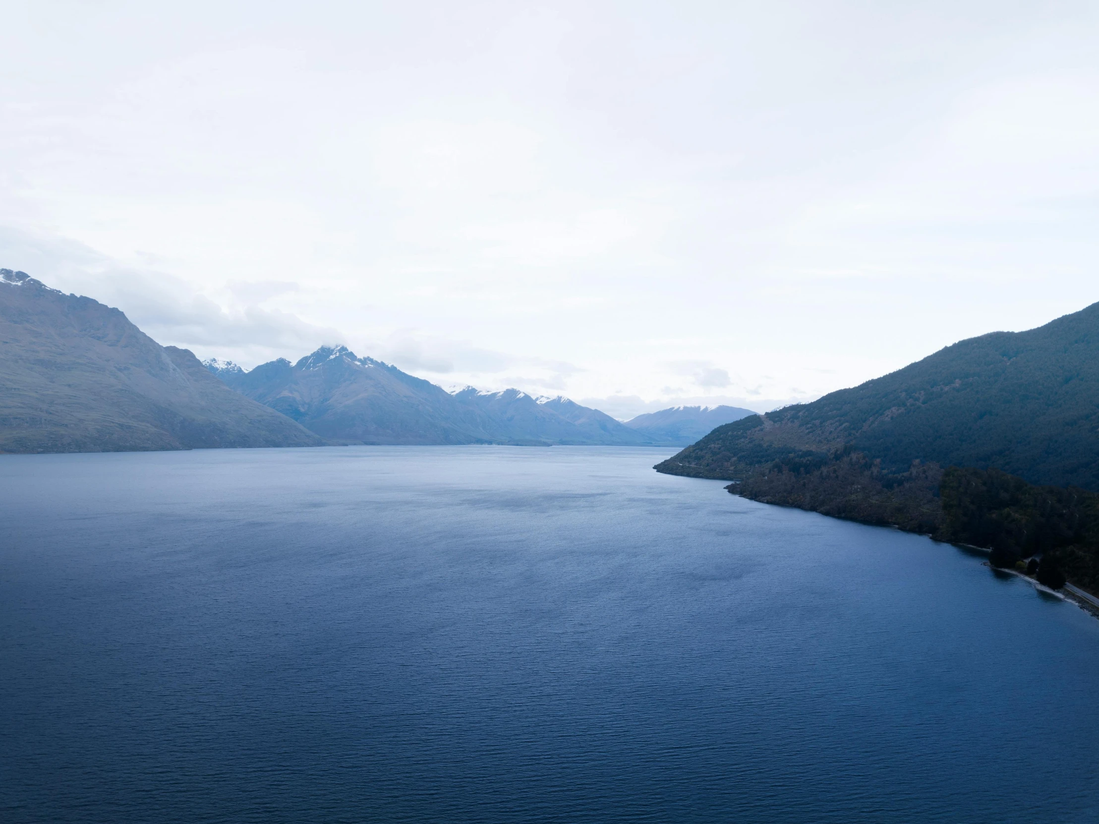 a large body of water surrounded by mountains, by Sophie Pemberton, unsplash, hurufiyya, picton blue, john pawson, ignant, videogame still