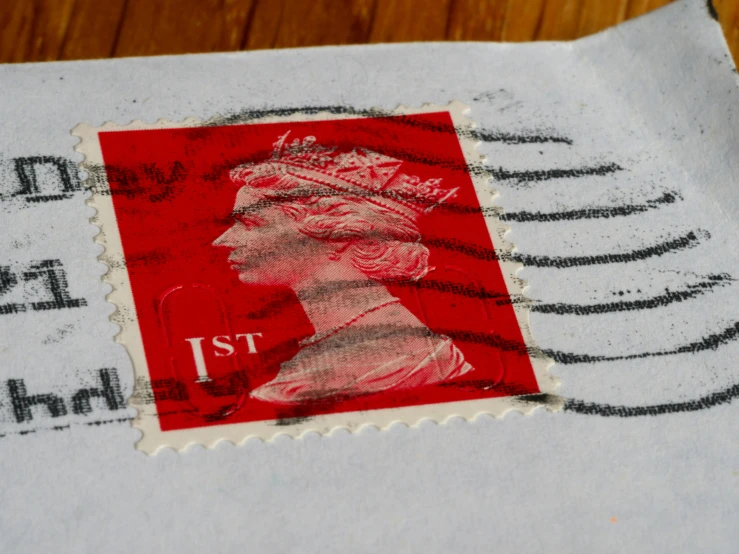 a close up of a stamp on a piece of paper, an album cover, by Joe Bowler, pexels contest winner, mail art, the iron lady, red, realistic image, ready to eat