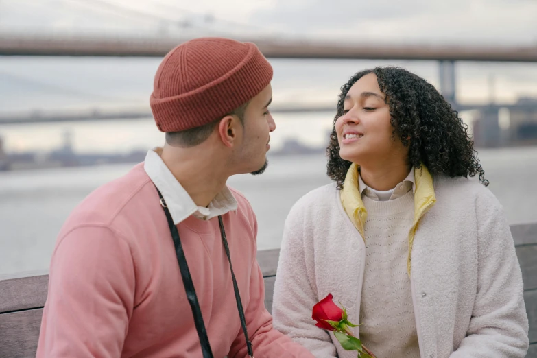 a man and woman sitting next to each other on a bench, pexels contest winner, holding a rose, mixed race, 1 4 9 3, on a bridge