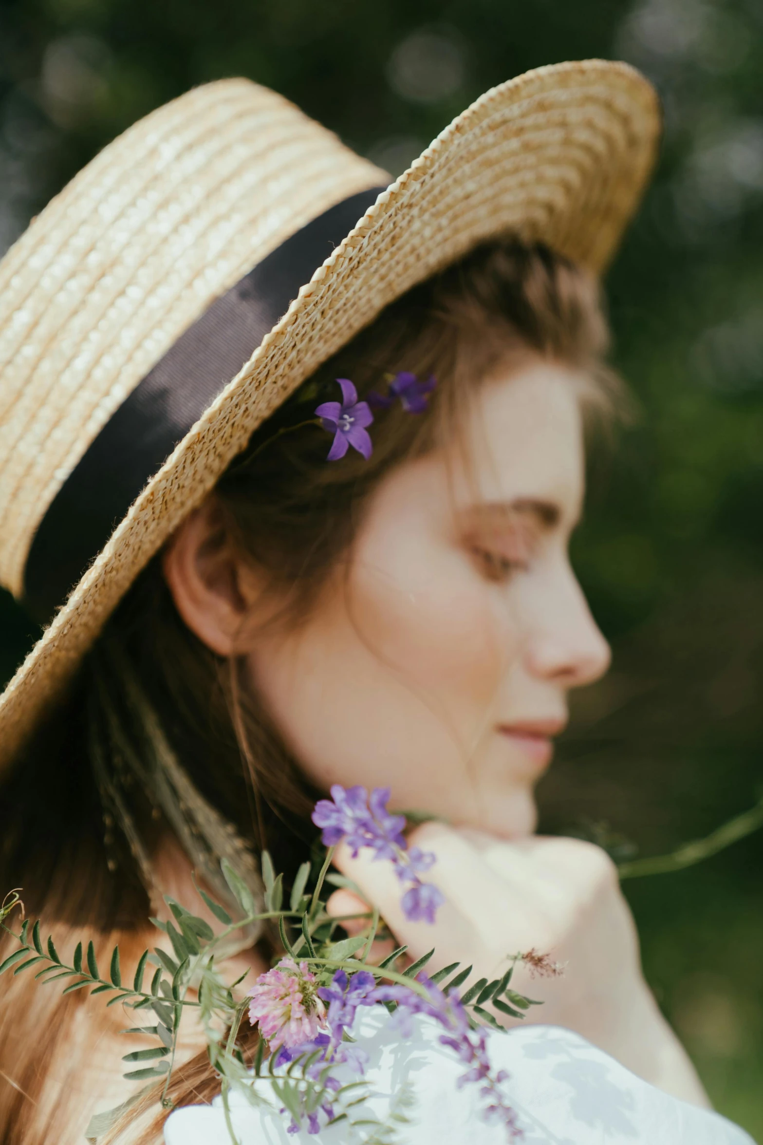 a woman wearing a straw hat with flowers in her hair, a portrait, trending on pexels, subtle purple accents, dreamy and ethereal, gardening, like a catalog photograph