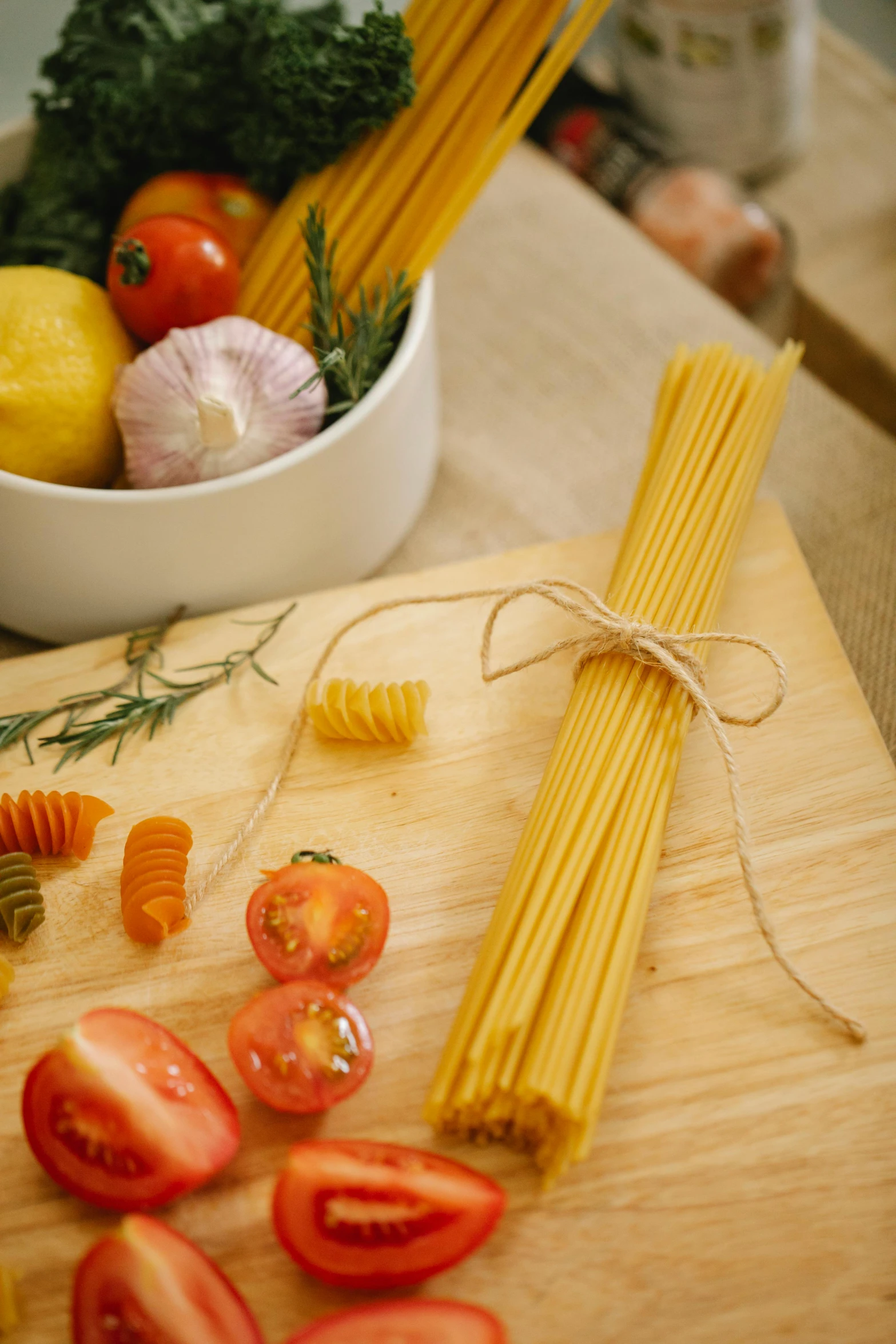 a wooden cutting board topped with pasta and tomatoes, renaissance, filaments, medium-shot, strings, organics