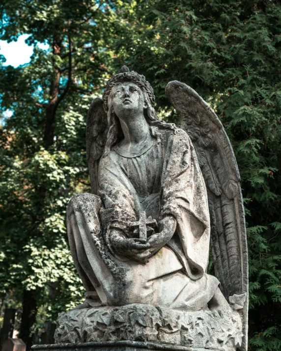 a statue of an angel in a cemetery, pexels contest winner, lgbtq, grey, a quaint, orthodox saint