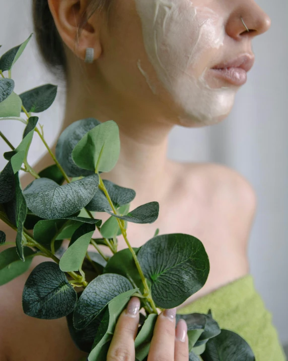 a close up of a person holding a plant, skincare, full mask, eucalyptus, profile image