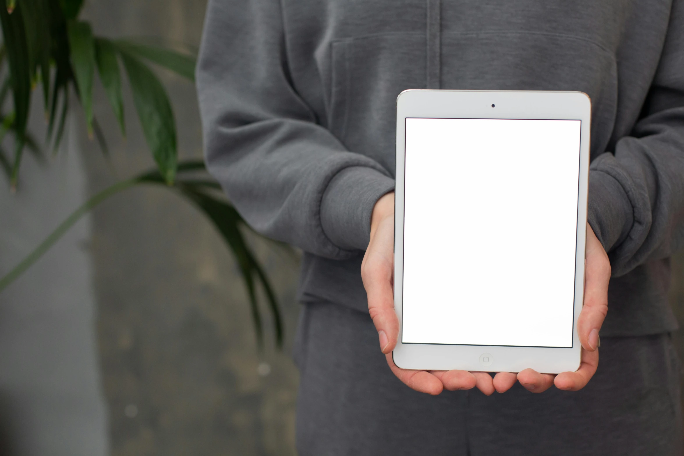 a person holding a tablet with a white screen, by Carey Morris, unsplash, smart textiles, light toned, background image