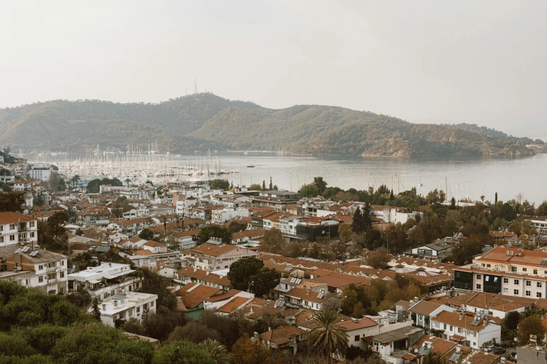 a view of a city from the top of a hill, by Carey Morris, pexels contest winner, hurufiyya, small port village, upscaled to high resolution, white, byzantine