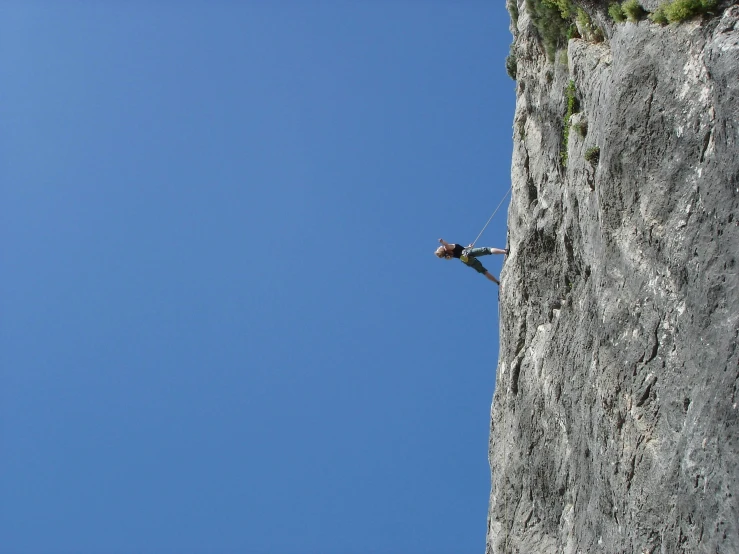 a man on a rock climbing up the side of a cliff, by Erwin Bowien, pexels contest winner, figuration libre, clear blue skies, limestone, hanging rope, 3 meters