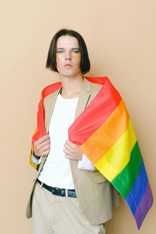 a man in a suit holding a rainbow flag, an album cover, by Jessie Alexandra Dick, orelsan, with a bob cut, photo for a magazine, julian ope