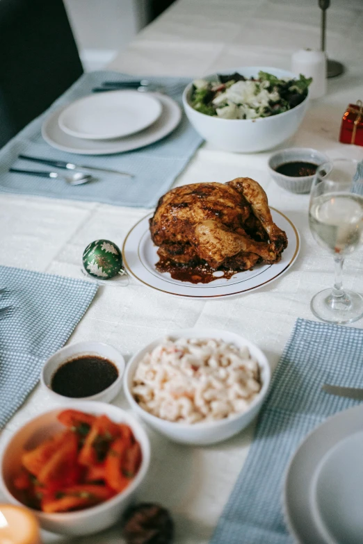 a table topped with plates and bowls of food, chicken, holiday season, profile image, stuffed