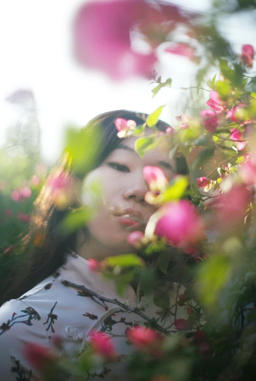 a woman standing in a field of flowers, a picture, inspired by Jung Park, unsplash, aestheticism, portrait of mulan, laying on roses, rosy cheeks, taken in the late 2010s