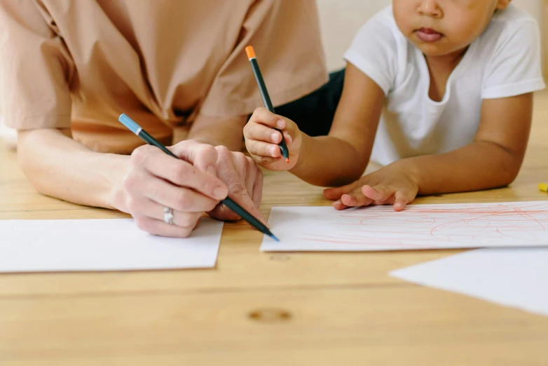 a woman sitting at a table with a child, a child's drawing, trending on pexels, academic art, brown, holding pencil, low quality photo, whiteboards