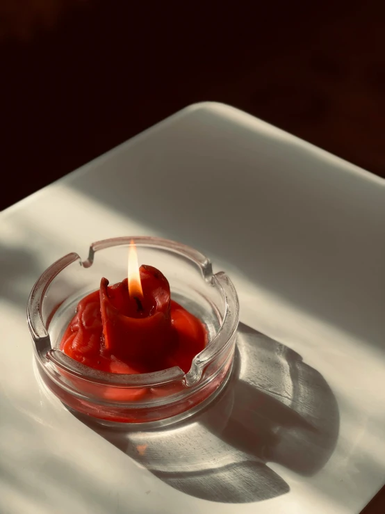 a small bowl of ketchup sitting on a table, by Nina Hamnett, trending on unsplash, process art, holding a candle holder, glowing inside, transparent background, red paint detail