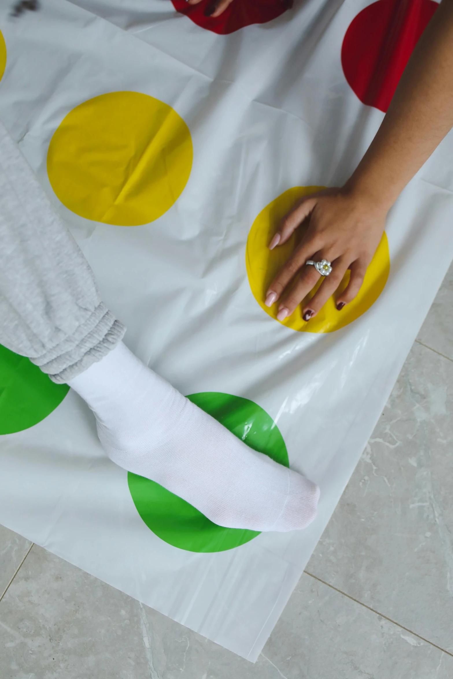 a person laying on top of a polka dot blanket, dribble, made of lab tissue, green and yellow, her foot sticking out, physical painting