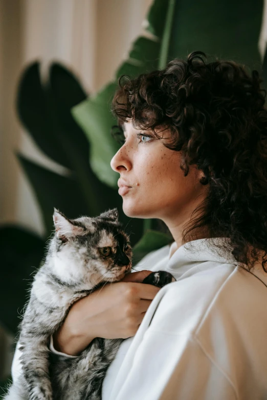a woman holding a cat in her arms, trending on pexels, renaissance, curly brown hair, thoughtful ), with a white, profile image