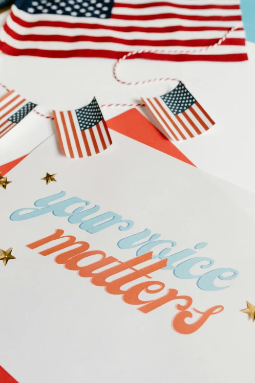 a bunch of cards sitting on top of a table, poster art, inspired by Americo Makk, shutterstock contest winner, international typographic style, stars and stripes, detail shot, paper craft, on white paper