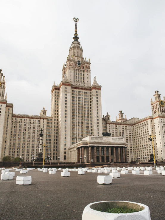 a large white planter sitting in front of a tall building, an album cover, by Marina Abramović, unsplash contest winner, socialist realism, red square moscow, three towers, cloud palace, 000 — википедия