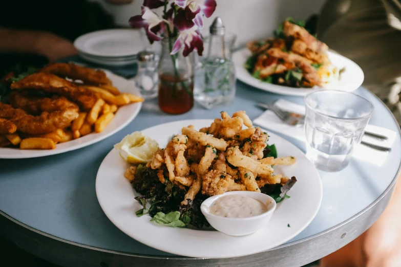 a table topped with plates of food next to a glass of water, by Carey Morris, pexels contest winner, serving fries, mad cuttlefish, melbourne, 🦩🪐🐞👩🏻🦳