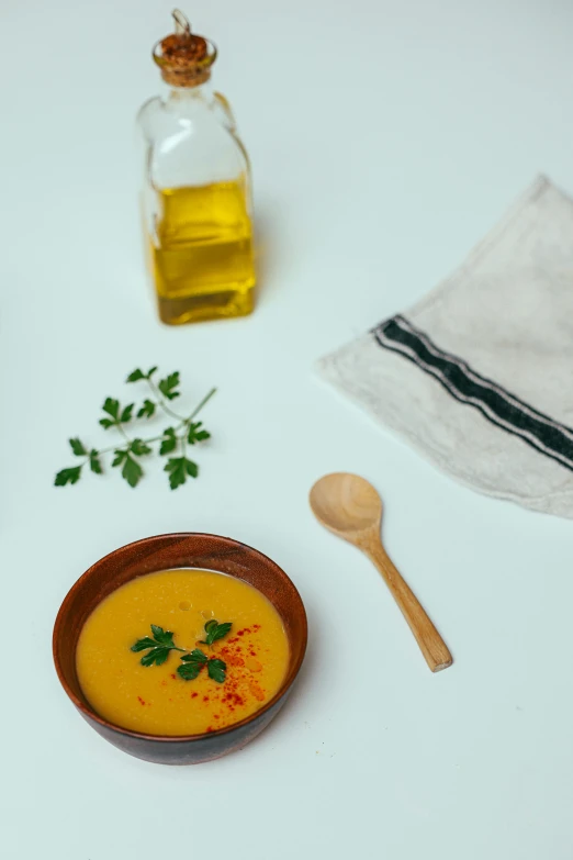 a bowl of soup sitting on top of a table, inspired by Ceferí Olivé, unsplash, dau-al-set, cooking oil, honey, high quality product image”, studio photo