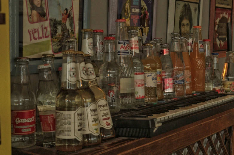 a row of liquor bottles sitting on top of a bar, a photorealistic painting, pexels, real pianos, soda cans, 1980s photo, redneck