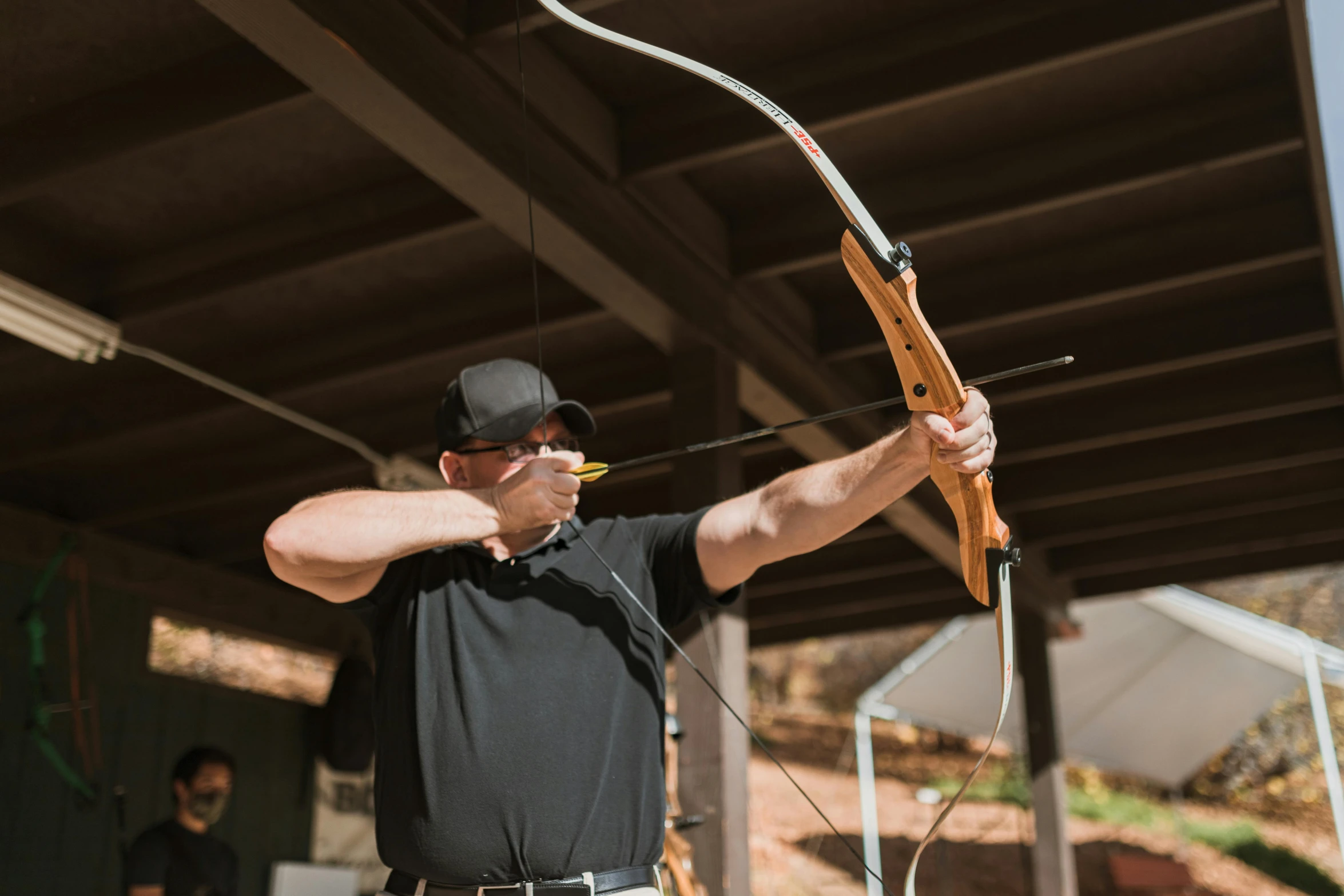 a man that is holding a bow and arrow, lynn skordal, medium level shot, fan favorite, camp