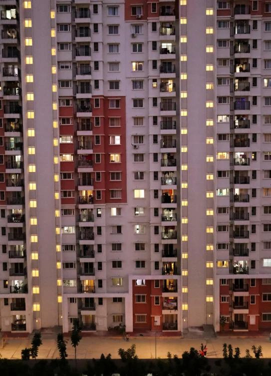 a group of tall buildings lit up at night, by Joze Ciuha, pexels contest winner, hyperrealism, soviet apartment building, panels, an overpopulated, ben lo