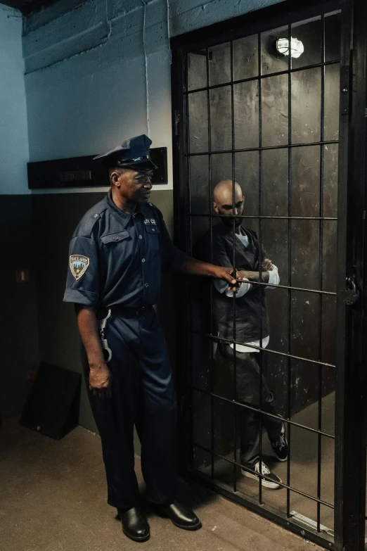 a couple of men standing next to each other in a jail cell, a colorized photo, pexels contest winner, police officer hit, shot on iphone 1 3 pro max, dave chappelle, ( ( theatrical ) )