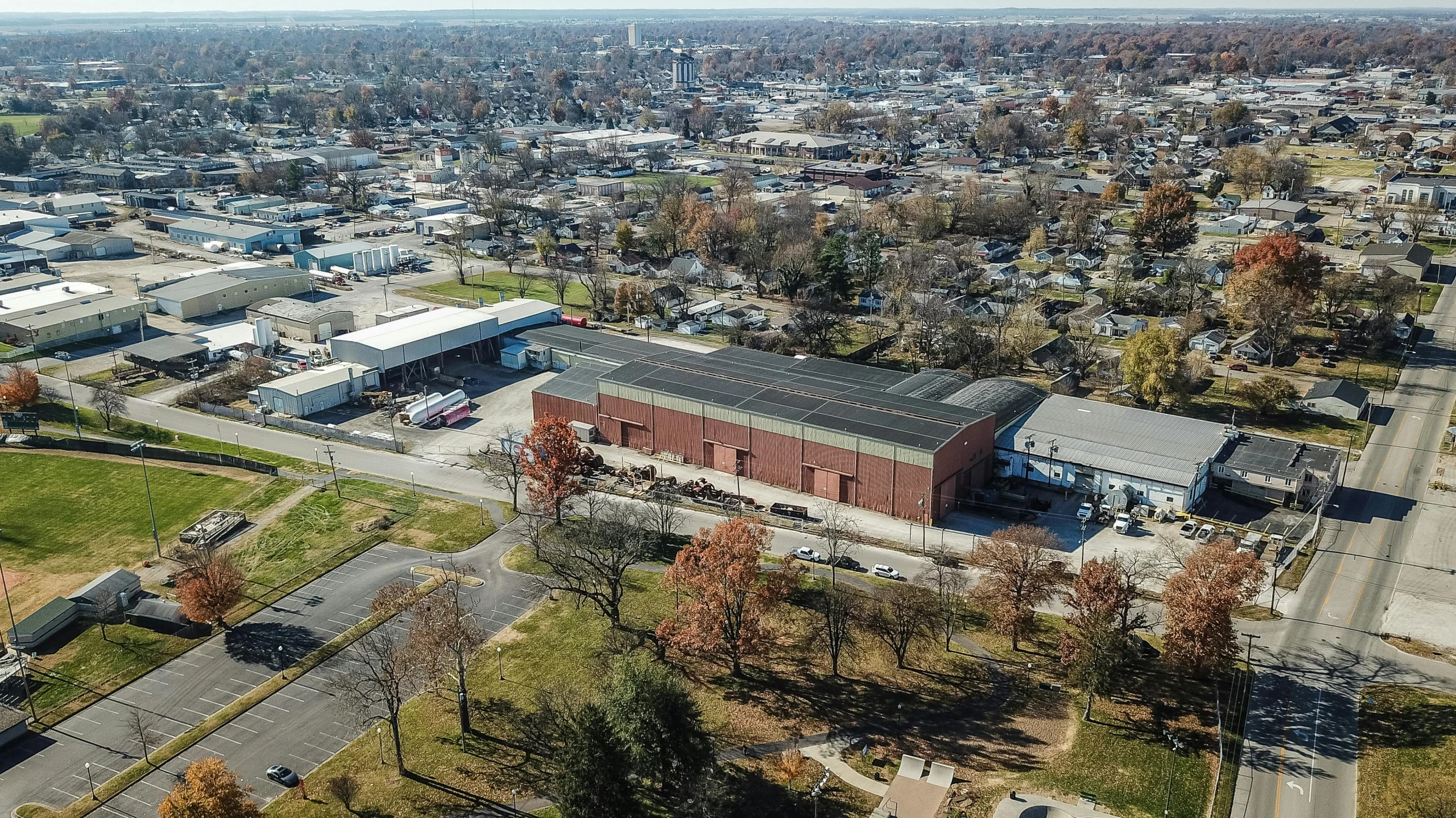 an aerial view of a city with lots of buildings, a portrait, by Dan Frazier, athletic crossfit build, bentonville arkansas, warehouses, taken in the early 2020s