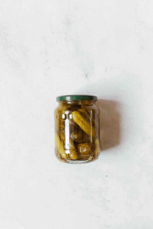 a jar of pickles on a white surface, a picture, pexels, vine, 8 h, brown, australian