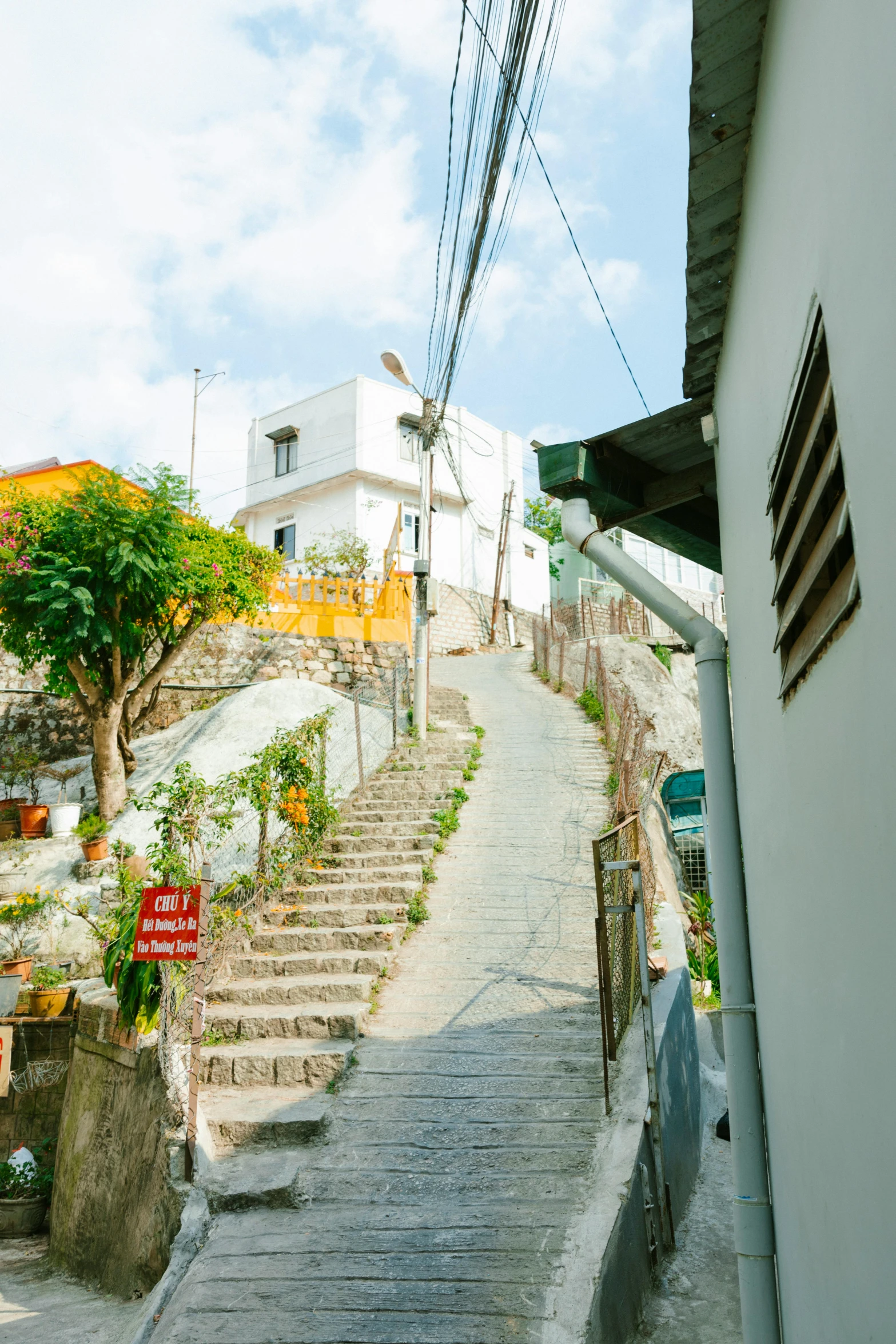 a person riding a skateboard down a set of stairs, quito school, the village on the cliff, walking down a street, lush surroundings, istanbul